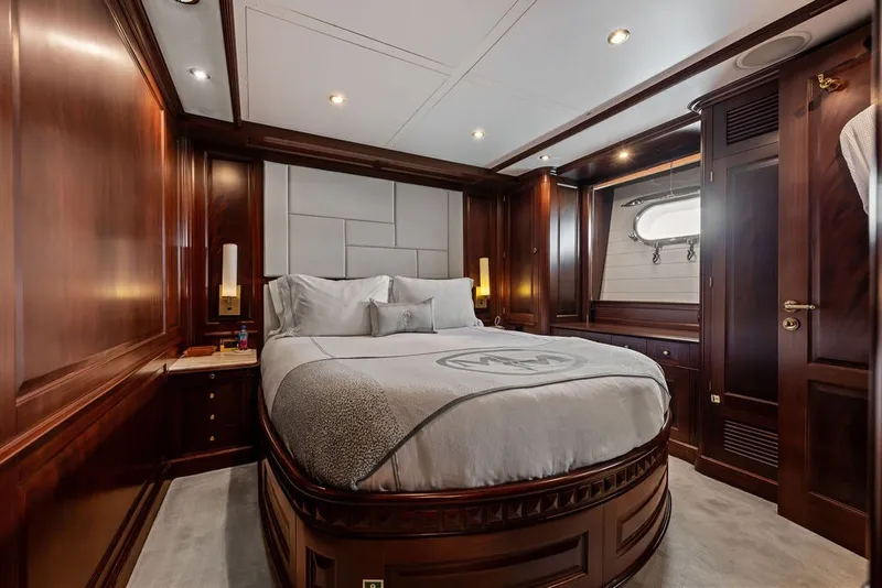 Slide: The Image of Luxurious bedroom interior on a 2007 Benetti 120 Classic yacht, featuring elegant wood paneling. - 118