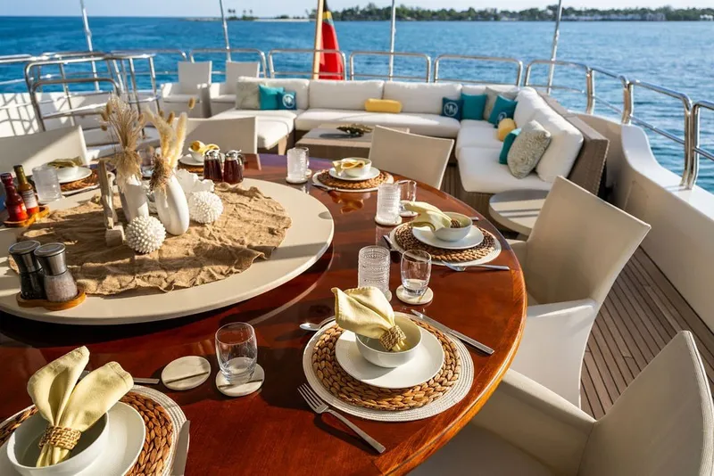 Slide: The Image of Luxurious dining setup on 2007 Benetti 120 Classic yacht, overlooking serene ocean views. - 148