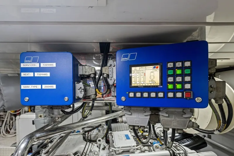 Slide: The Image of Engine control panel of a 2007 Benetti 120 Classic yacht, featuring MTU service details. - 164