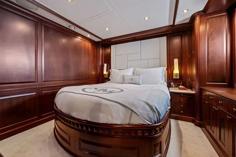 Slide: The Image of Luxurious bedroom with rich wood paneling on a 2007 Benetti 120 Classic yacht. - 121