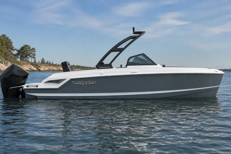Slide: The Image of 2027 Monterey Elite 23 OB boat on calm water, sleek design, scenic background. - 2