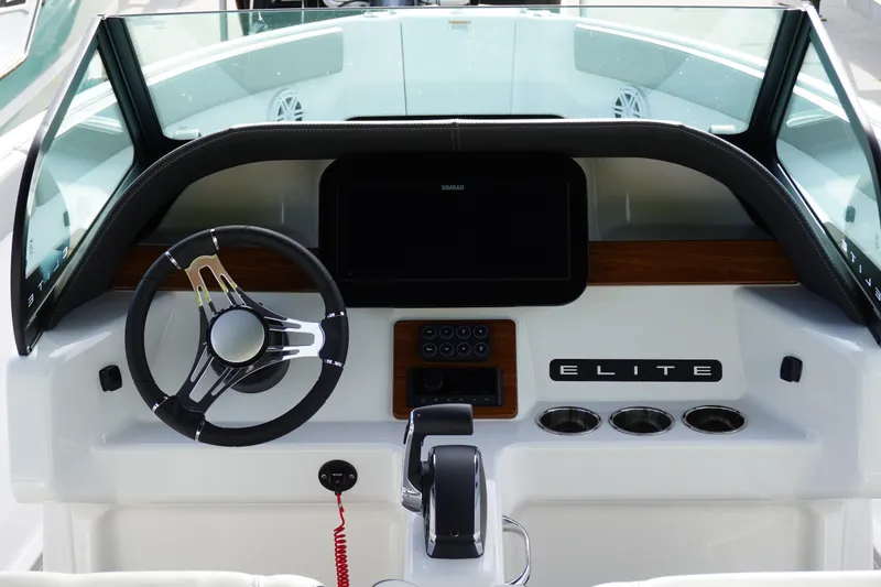 Slide: The Image of Cockpit of 2027 Monterey Elite 23 OB boat with modern steering and controls. - 10