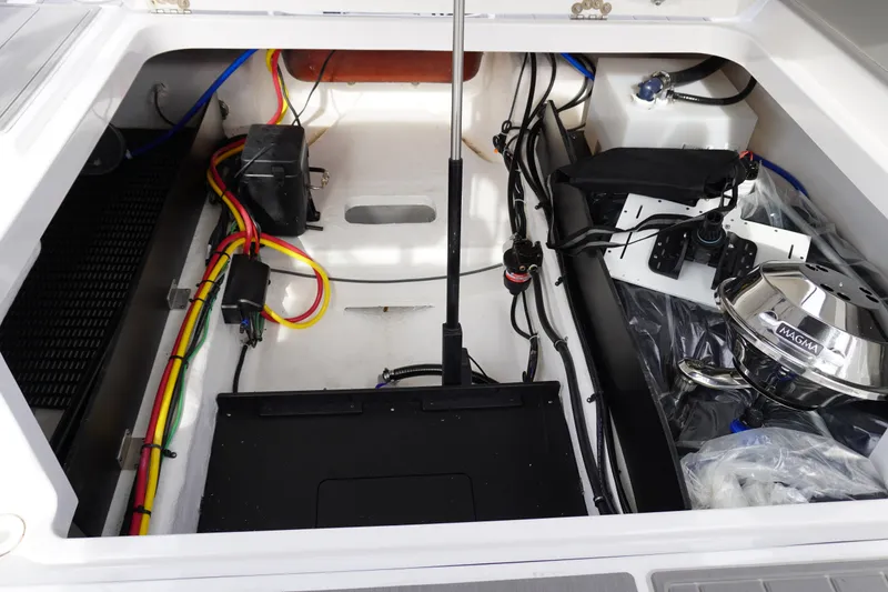 Slide: The Image of Open engine compartment of 2027 Monterey Elite 23 OB boat, showcasing wiring and components. - 7
