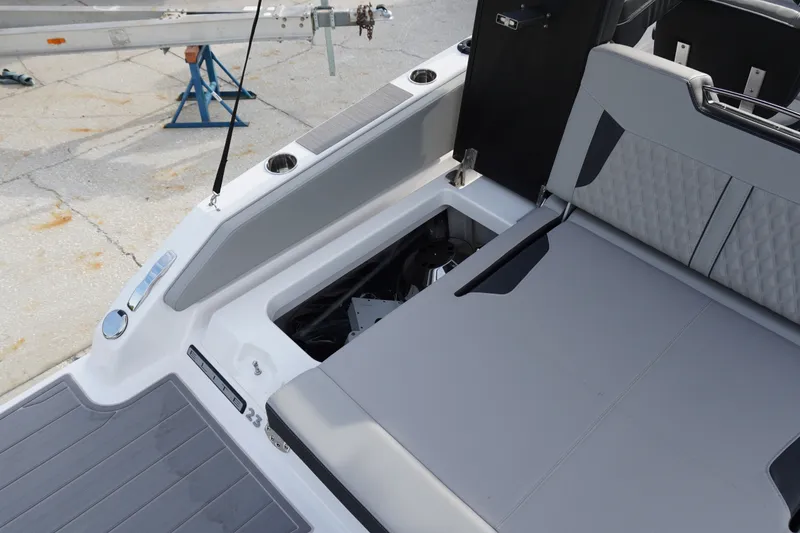 Slide: The Image of 2027 Monterey Elite 23 OB boat interior with open storage compartment and seating area. - 5
