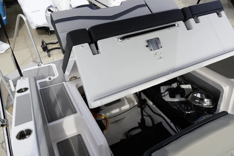 Slide: The Image of 2027 Monterey Elite 23 OB boat interior with open storage compartment and seating. - 6