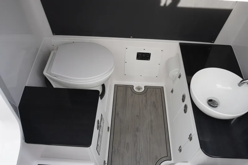 Slide: The Image of 2027 Monterey Elite 23 OB boat bathroom with toilet, sink, and modern design. - 14