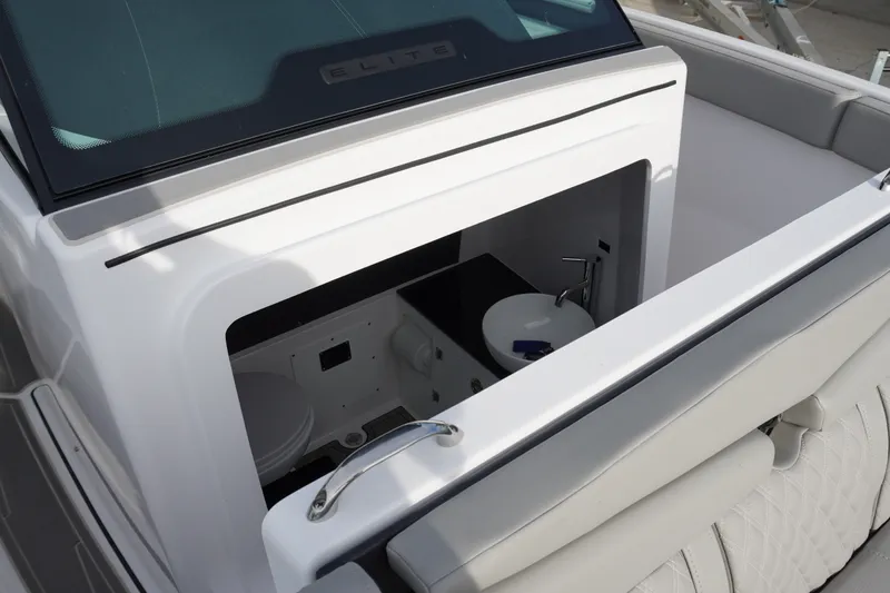 Slide: The Image of Interior view of 2027 Monterey Elite 23 OB boat's compact bathroom area. - 13