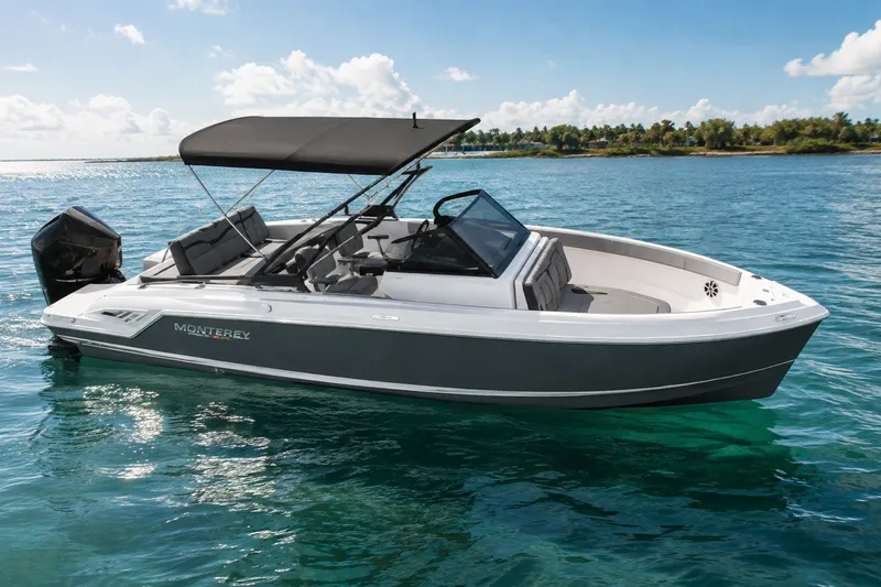 Slide: The Image of 2027 Monterey Elite 23 OB boat cruising on clear blue water. - 1
