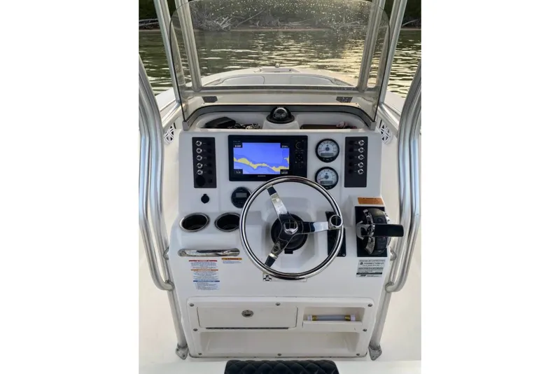 Slide: The Image of 2018 Robalo R202 Explorer boat dashboard with steering wheel and navigation display. - 5