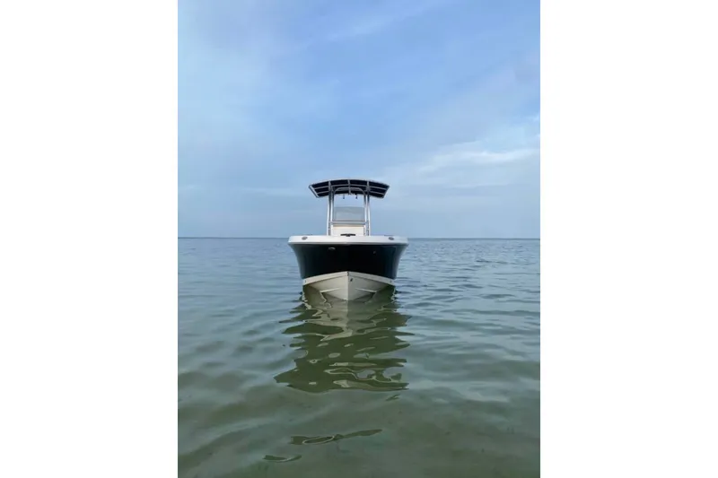Slide: The Image of 2018 Robalo R202 Explorer boat on calm water under a clear sky. - 1