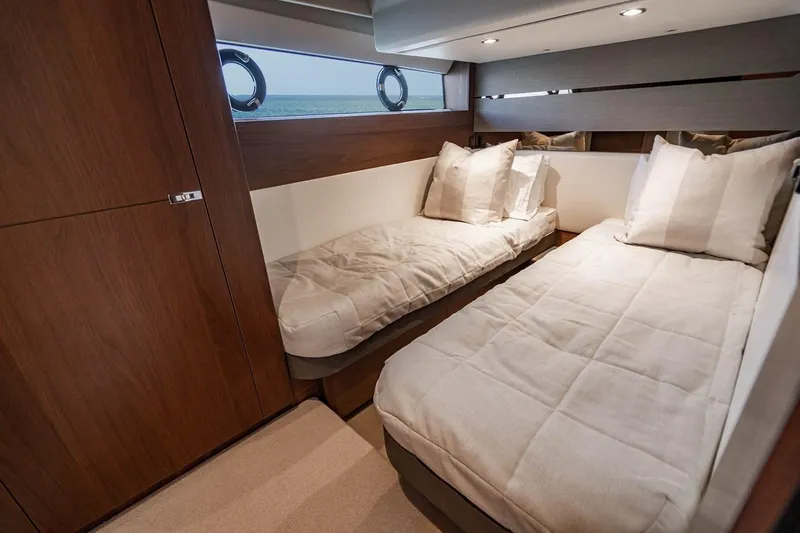 Slide: The Image of Cabin of the 2020 Princess V60 with twin beds and wood furnishings. - 26