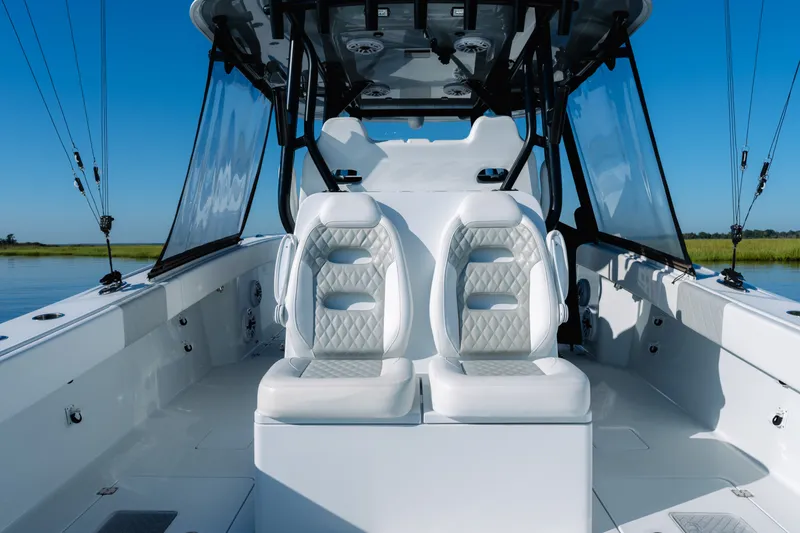 Slide: The Image of 2023 Freeman 34VH boat interior with luxurious white seating and clear blue sky. - 27