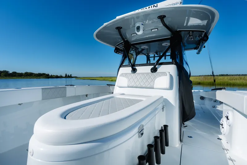 Slide: The Image of 2023 Freeman 34VH boat interior with sleek seating and modern design on a calm waterway. - 16