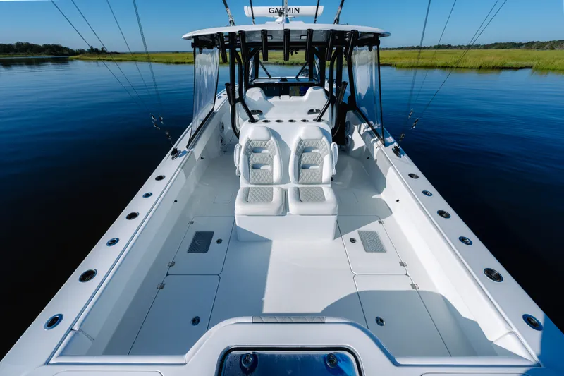 Slide: The Image of 2023 Freeman 34VH boat with sleek design on calm water. - 25