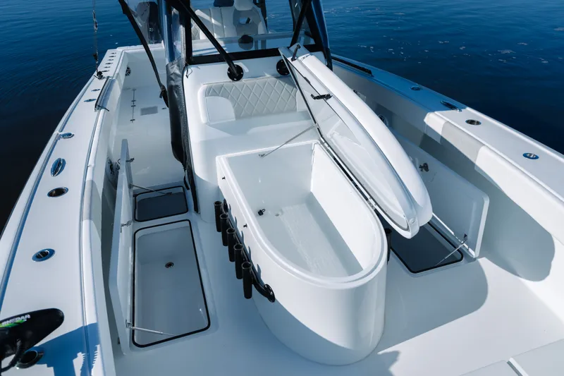 Slide: The Image of 2023 Freeman 34VH boat interior with open storage compartments on calm water. - 17