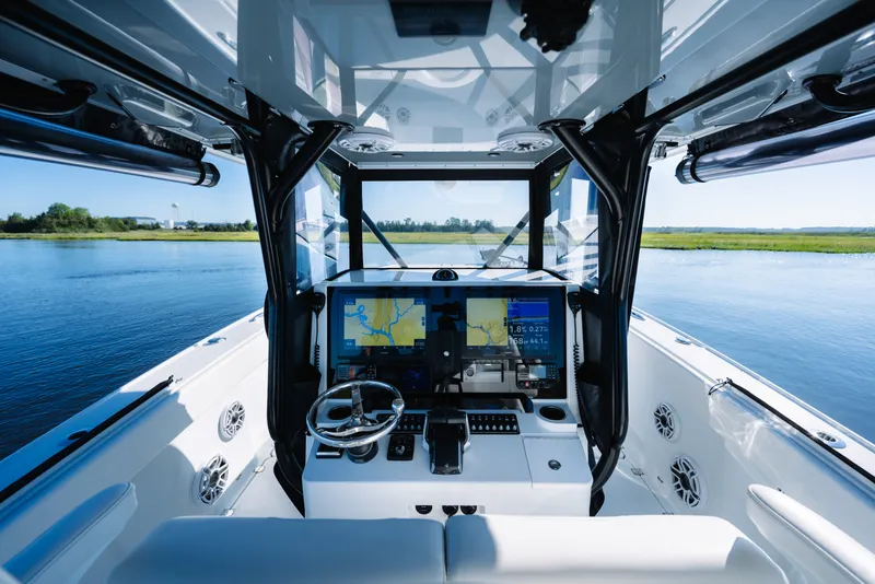 Slide: The Image of Interior view of 2023 Freeman 34VH boat cockpit with navigation screens and steering wheel. - 18