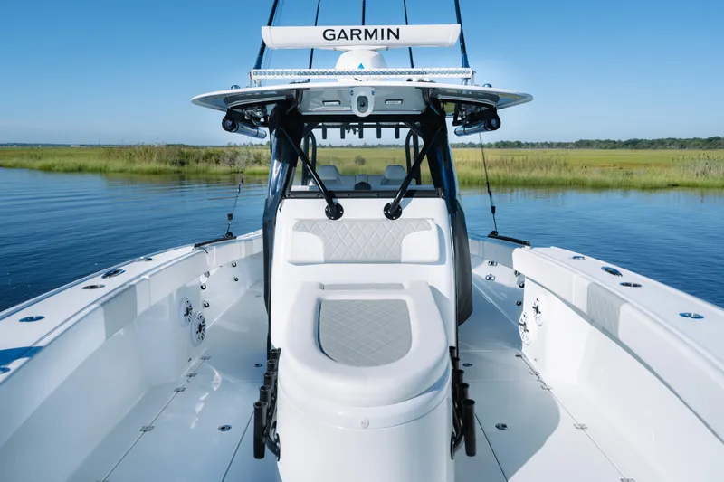 Slide: The Image of 2023 Freeman 34VH boat on calm water, featuring Garmin equipment and sleek design. - 14