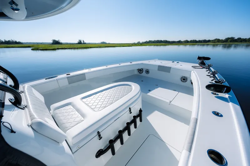 Slide: The Image of 2023 Freeman 34VH boat interior with white seating on calm water. - 15