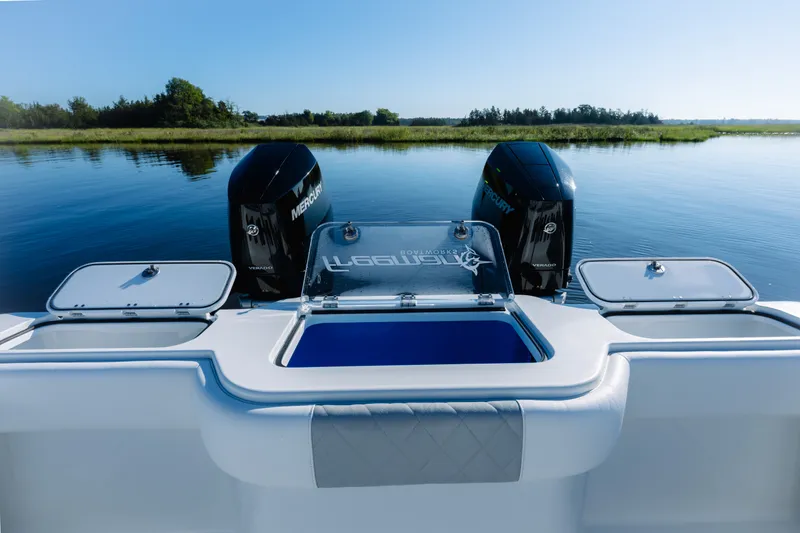 Slide: The Image of Freeman 34VH 2023 boat with dual Mercury engines on a serene lake. - 30