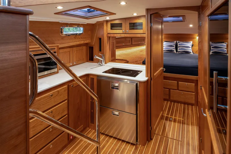 Slide: The Image of Luxurious interior of 2027 Sabre 38 Salon Express yacht with modern kitchen and cozy bedroom. - 15