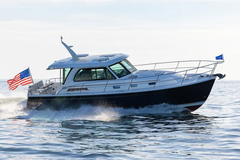 Slide: The Image of Manufacturer Provided Image: 2027 Sabre 38 Salon Express cruising on open water with American flag. - 3