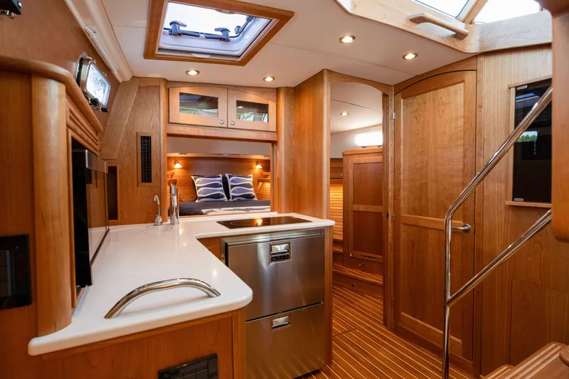 Slide: The Image of Luxurious interior of 2027 Sabre 38 Salon Express yacht with modern kitchen and cozy bedroom. - 16