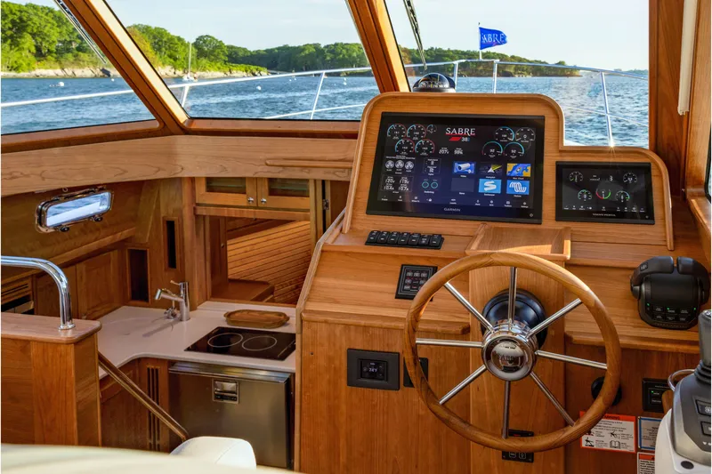 Slide: The Image of Interior of 2027 Sabre 38 Salon Express yacht with modern helm and navigation displays. - 10