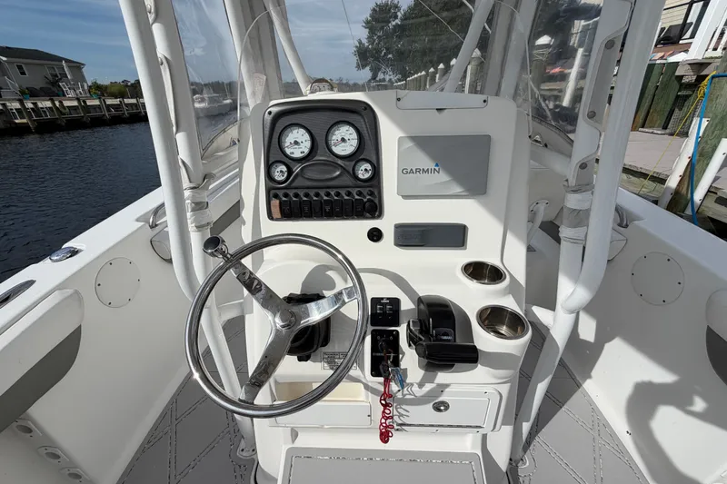 Slide: The Image of 2014 Tidewater 230 LXF boat console with Garmin navigation and steering wheel. - 13