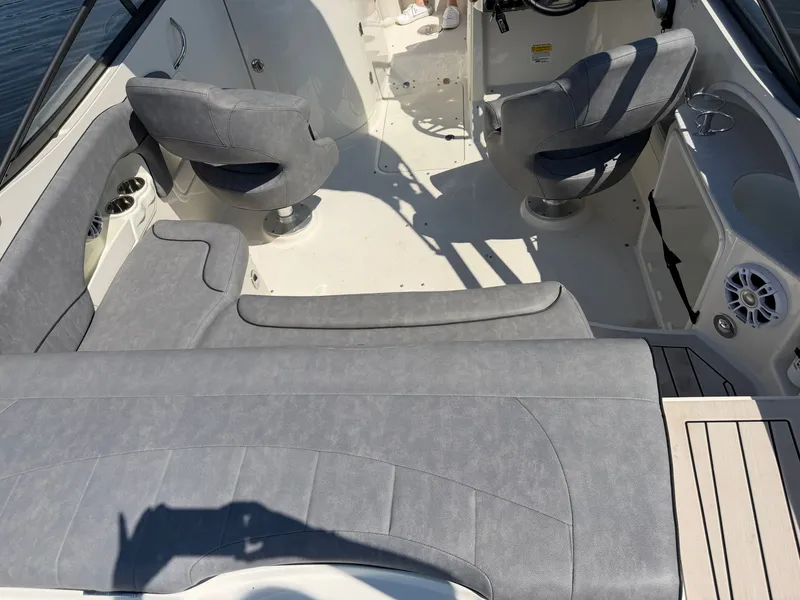 Slide: The Image of The image shows the cockpit of a 2021 Stingray 214 LR boat with gray seating. - 16