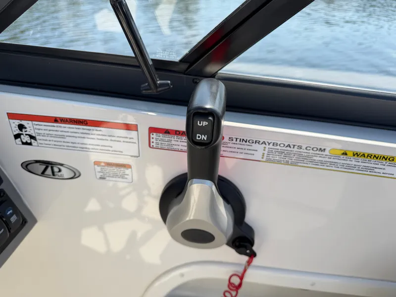 Slide: The Image of Close-up of a boat throttle lever with up and down buttons, surrounded by warning labels. - 13