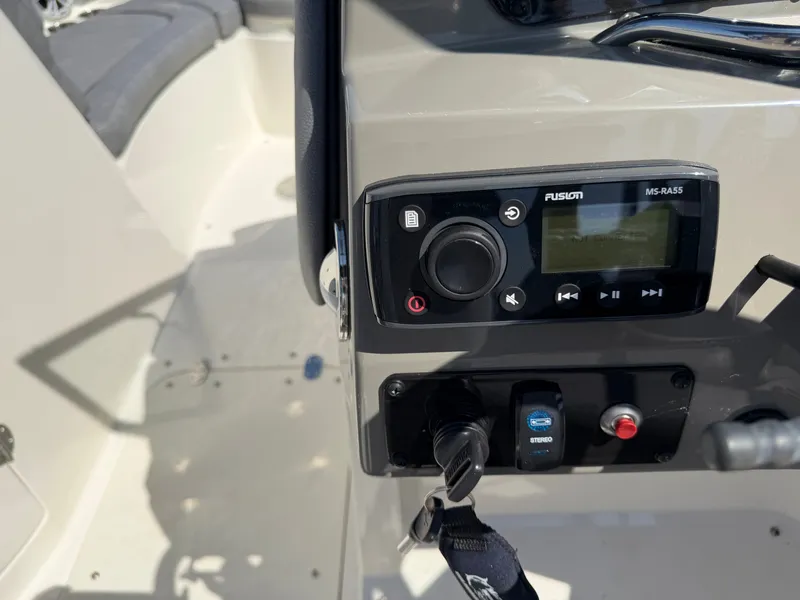 Slide: The Image of The image shows a boat's dashboard with a Fusion MS-RA55 radio. - 12