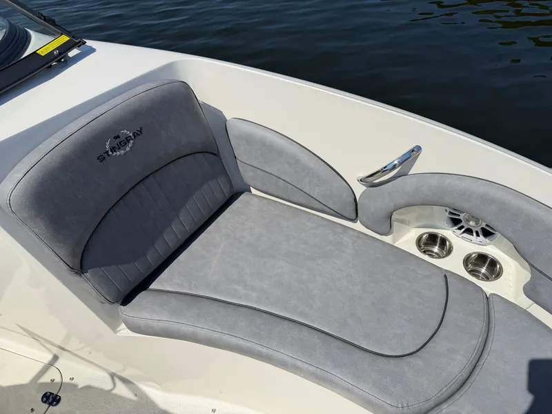Slide: The Image of The image shows the gray upholstery of a 2021 Stingray 214 LR, on calm water. - 11