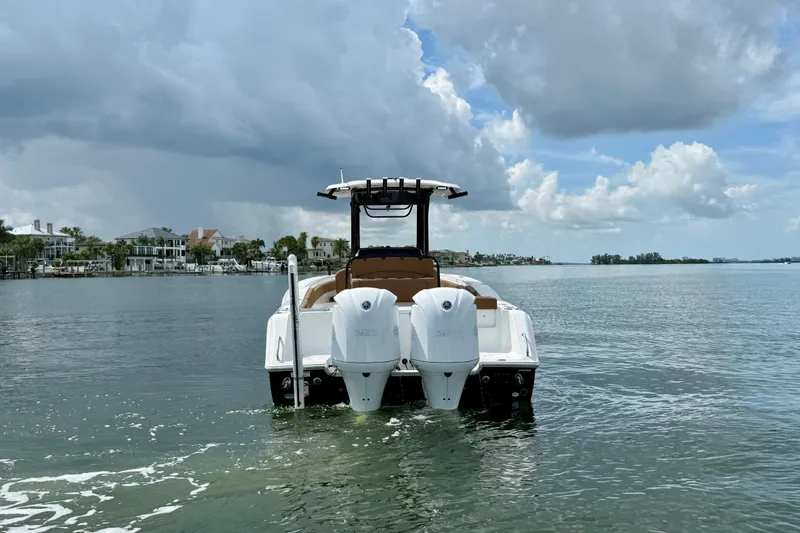 Slide: The Image of 2021 Sea Hunt Gamefish 27FS boat on calm water under cloudy sky. - 25