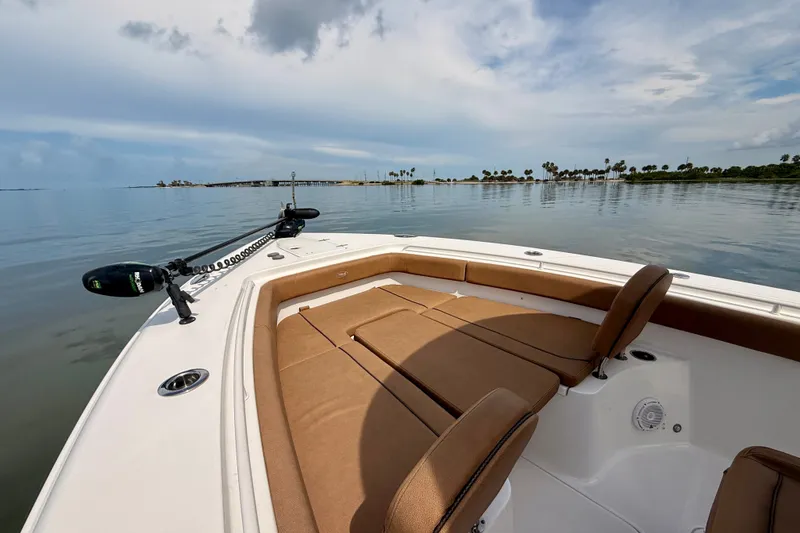 Slide: The Image of 2021 Sea Hunt Gamefish 27FS boat on calm water with clear sky. - 12