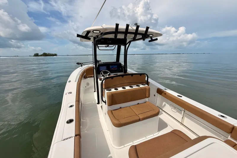 Slide: The Image of 2021 Sea Hunt Gamefish 27FS boat on calm water, featuring spacious seating and modern design. - 2