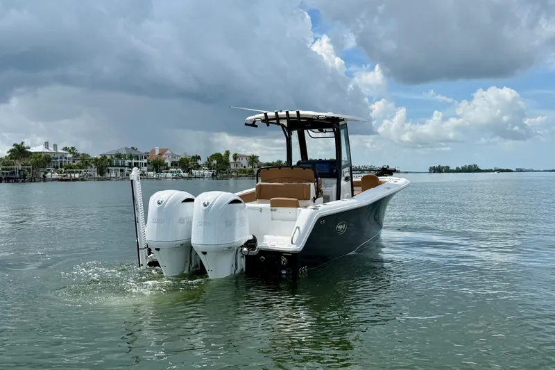 Slide: The Image of 2021 Sea Hunt Gamefish 27FS boat on calm water under cloudy sky. - 1
