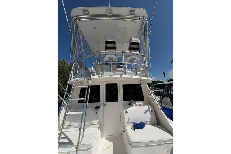 Slide: The Image of 2006 Cabo 35 Flybridge boat with ladder and seating, viewed from the stern. - 28