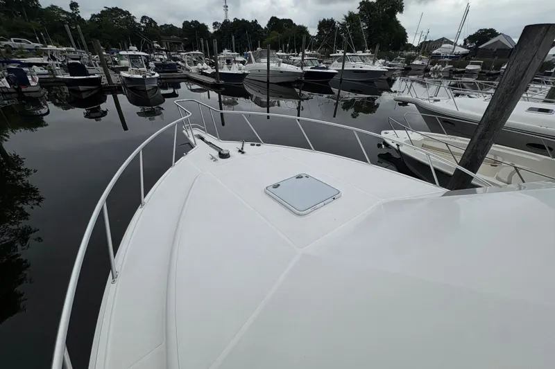 Slide: The Image of Bow view of 2006 Cabo 35 Flybridge yacht docked at marina. - 39