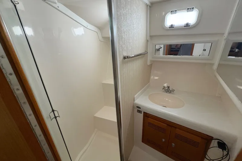 Slide: The Image of Bathroom interior of 2006 Cabo 35 Flybridge yacht, featuring shower and sink. - 16