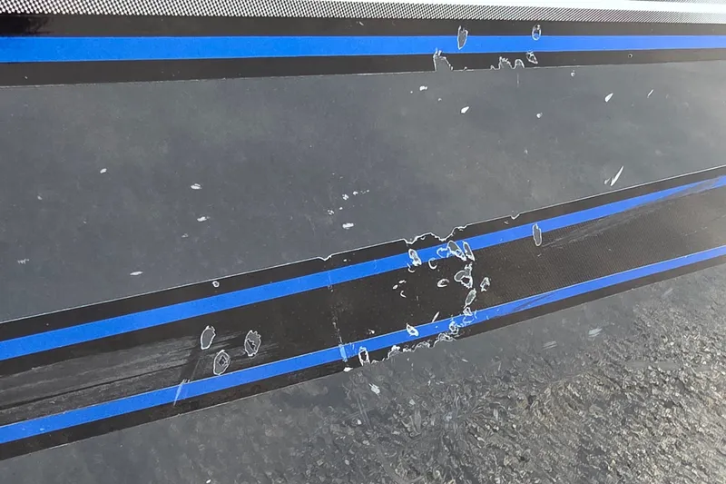 Slide: The Image of 2021 Ranger VS1882 WT boat with damaged blue and black stripe detailing. - 26