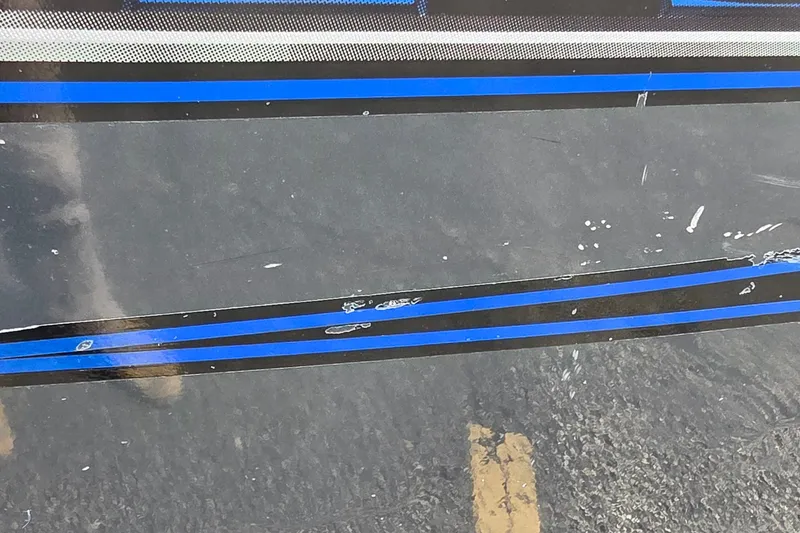 Slide: The Image of Close-up of 2021 Ranger VS1882 WT boat with blue and black stripes. - 7