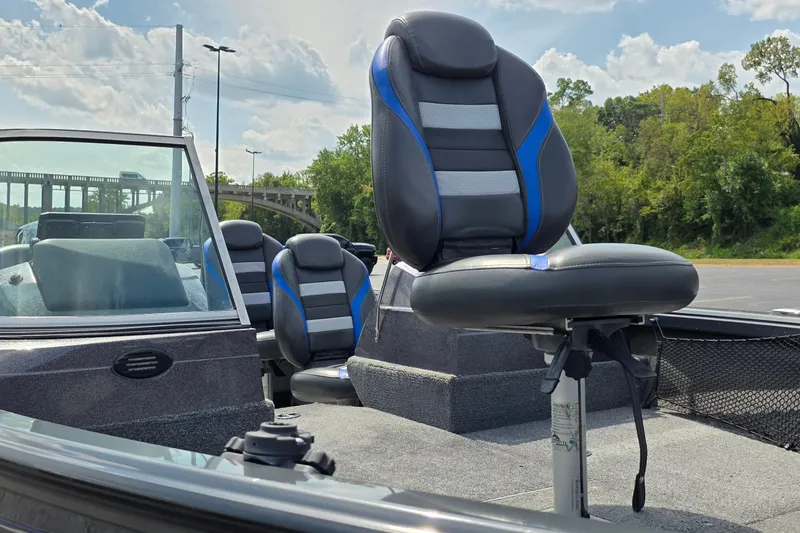Slide: The Image of 2021 Ranger VS1882 WT boat seats with blue accents, parked outdoors. - 12