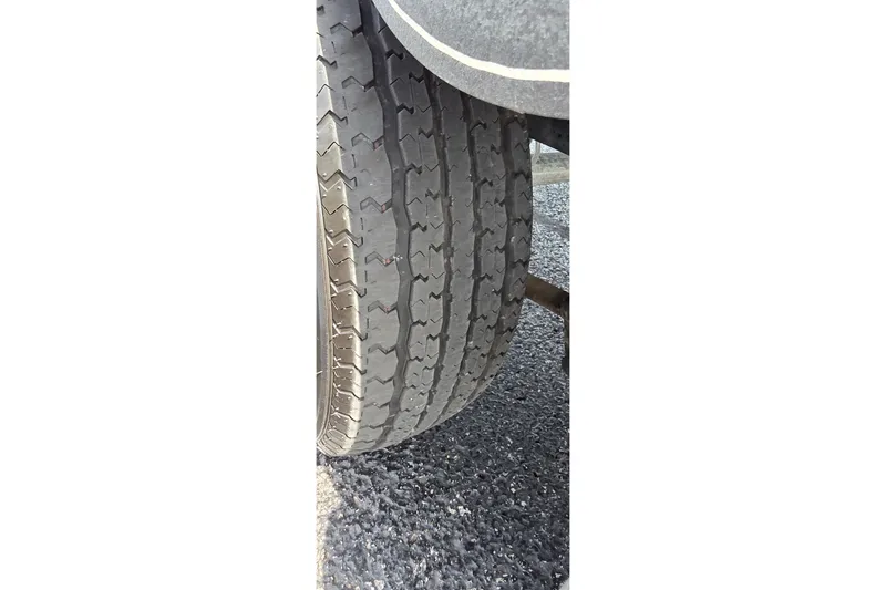 Slide: The Image of Close-up of a 2021 Ranger VS1882 WT tire on asphalt surface. - 28