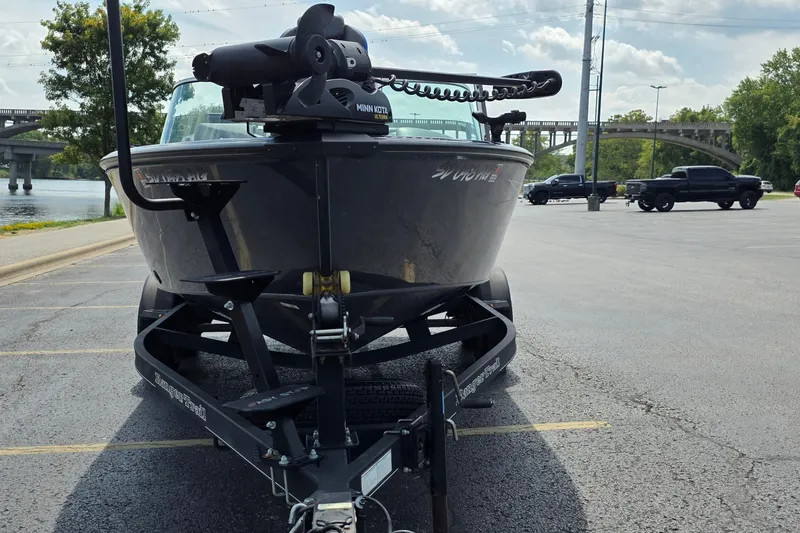 Slide: The Image of 2021 Ranger VS1882 WT boat on trailer in parking lot near river. - 4