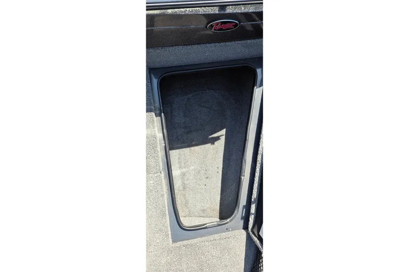 Slide: The Image of 2021 Ranger VS1882 WT boat storage compartment with carpeted interior. - 36