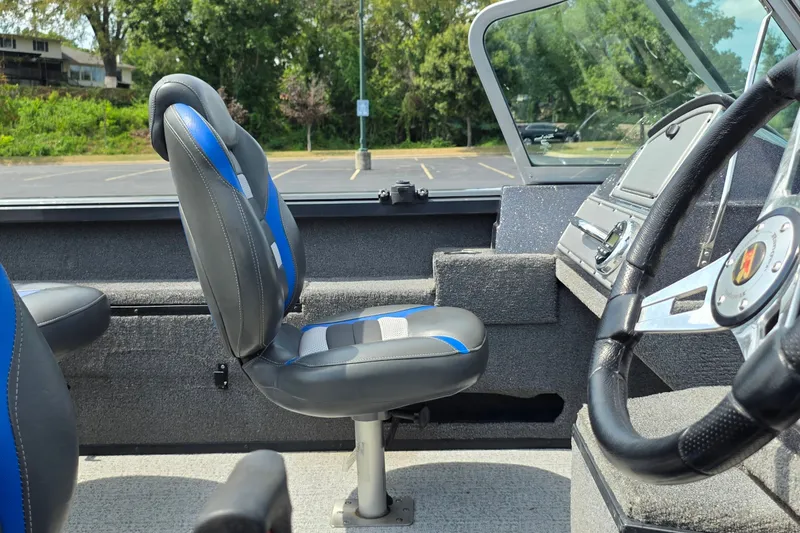 Slide: The Image of 2021 Ranger VS1882 WT boat interior with steering wheel and blue-accented seats. - 15