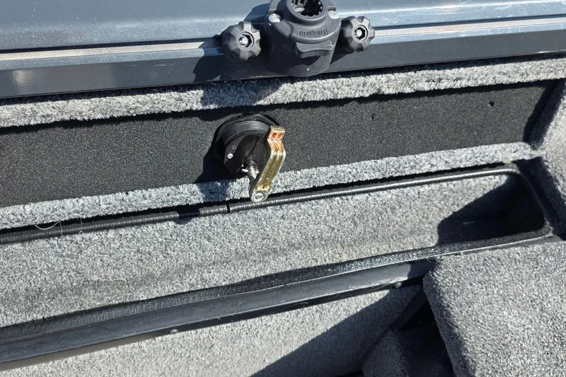 Slide: The Image of 2021 Ranger VS1882 WT boat interior with carpeted storage compartment and latch. - 30