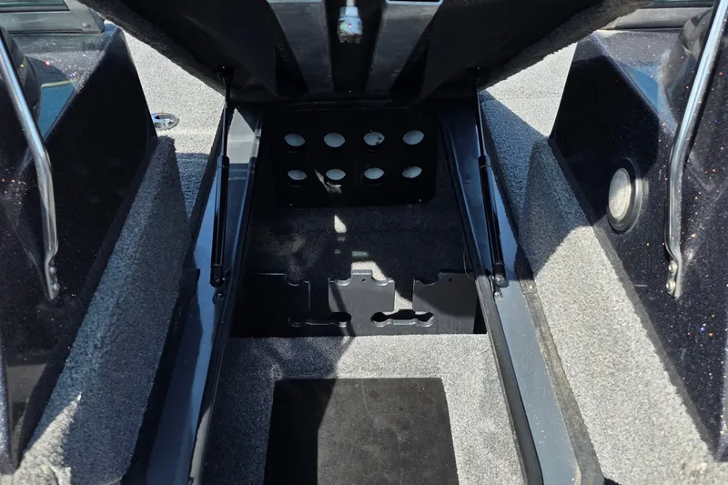 Slide: The Image of Open storage compartment in 2021 Ranger VS1882 WT boat, featuring carpeted interior and metal supports. - 34