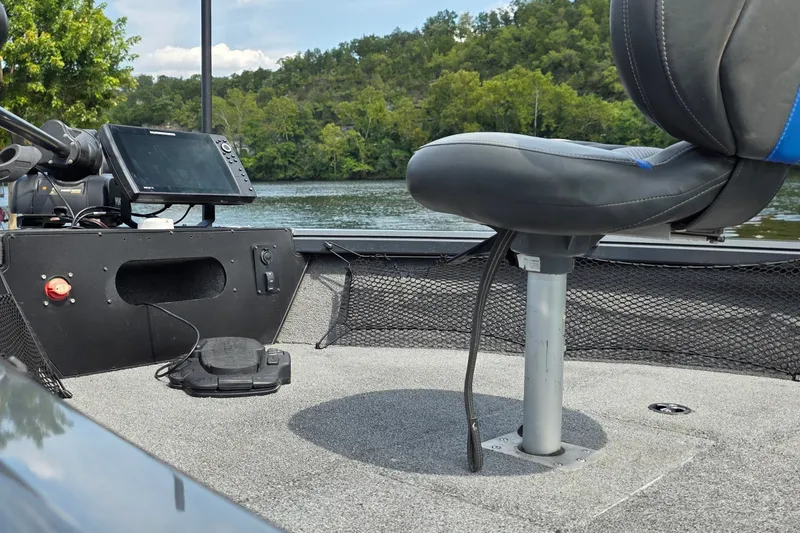 Slide: The Image of 2021 Ranger VS1882 WT boat interior with seat, control panel, and scenic lake view. - 22