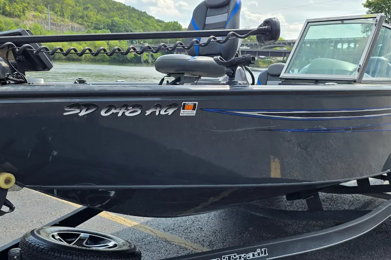 Slide: The Image of 2021 Ranger VS1882 WT boat on trailer by a river, featuring sleek design and blue accents. - 5